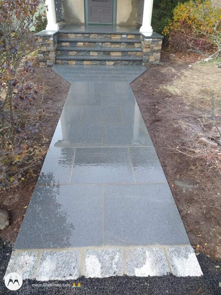 Stone-veneer porch with bluestone walkway leading up to it